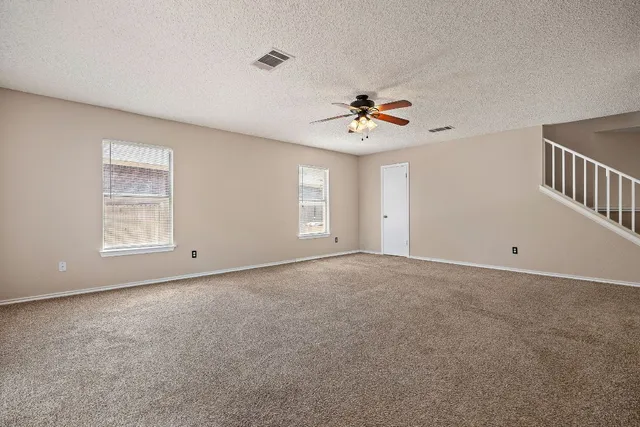 a view of a kitchen with a sink and a refrigerator