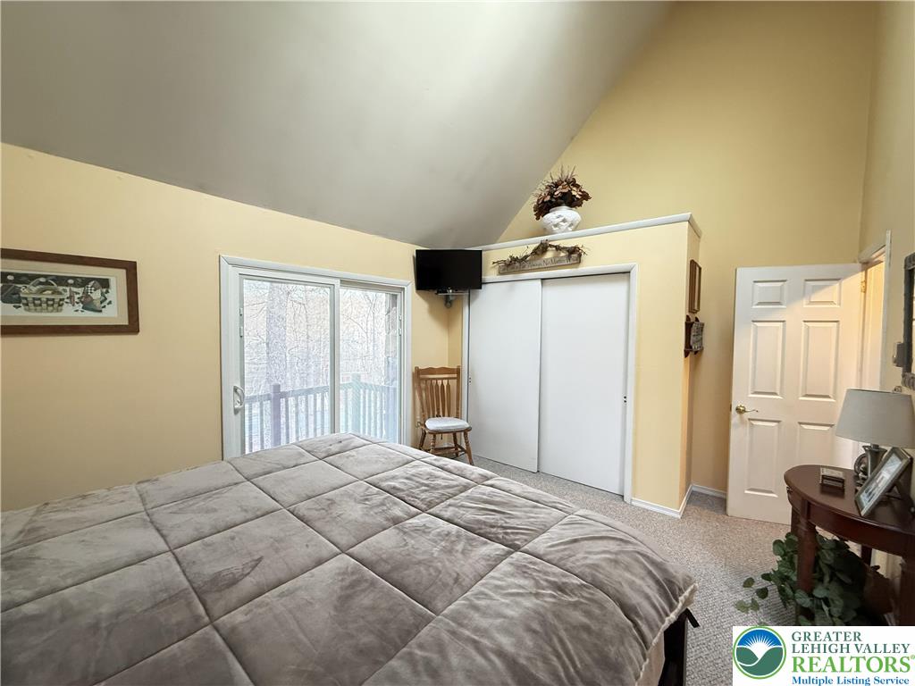 5933 Decker Road Bushkill, PA 18324 - Photo 12 of 51 a bedroom with a bed and wooden floor