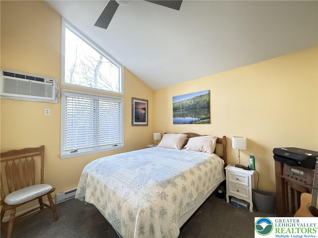 5933 Decker Road Bushkill, PA 18324 - Photo 17 of 51 a bedroom with a bed and wooden floor