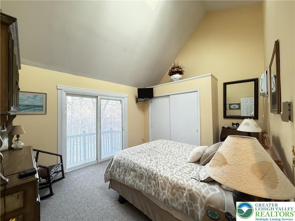 5933 Decker Road Bushkill, PA 18324 - Photo 19 of 51 a bedroom with a bed and a flat tv screen on dresser