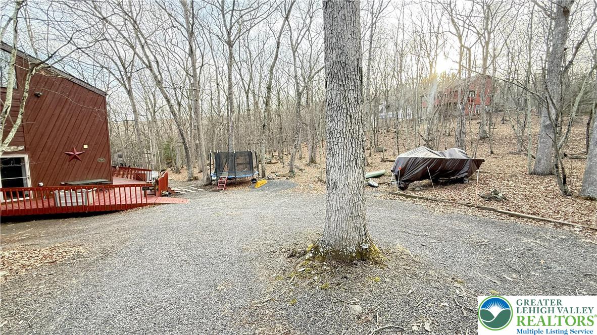 5933 Decker Road Bushkill, PA 18324 - Photo 3 of 51 a view of a street with a bench and trees