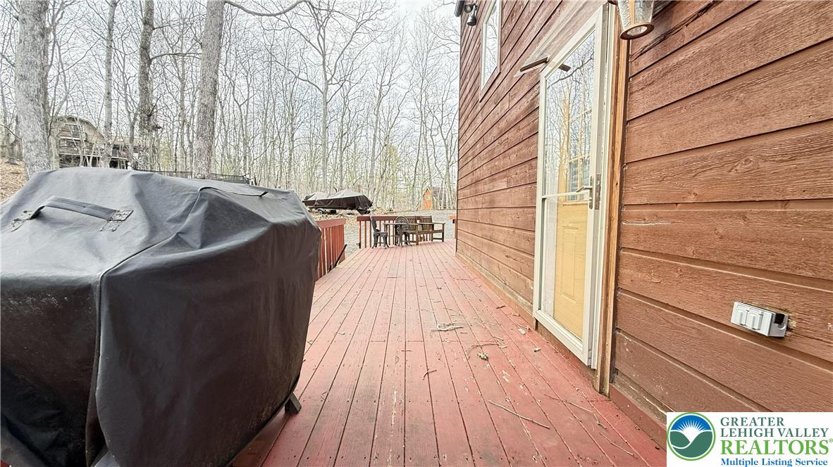 5933 Decker Road Bushkill, PA 18324 - Photo 4 of 51 a balcony with wooden floor and furniture