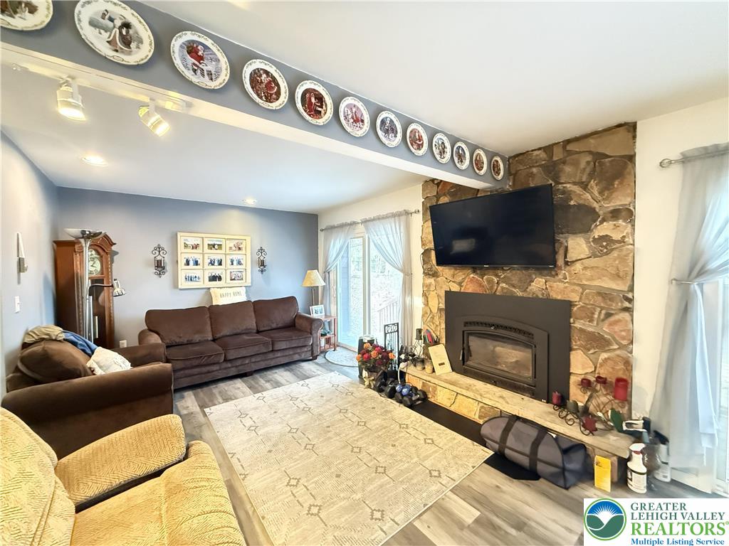 5933 Decker Road Bushkill, PA 18324 - Photo 5 of 51 a living room with furniture a flat screen tv and a fireplace