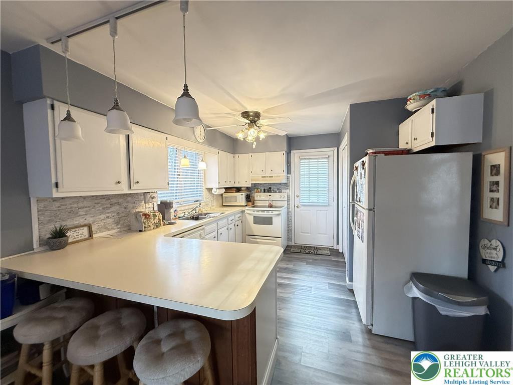 5933 Decker Road Bushkill, PA 18324 - Photo 8 of 51 a kitchen with stainless steel appliances granite countertop a sink refrigerator and cabinets