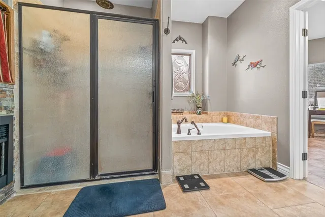 a bathroom with a bathtub and shower
