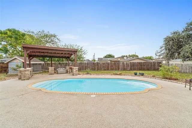 a view of a backyard with fence