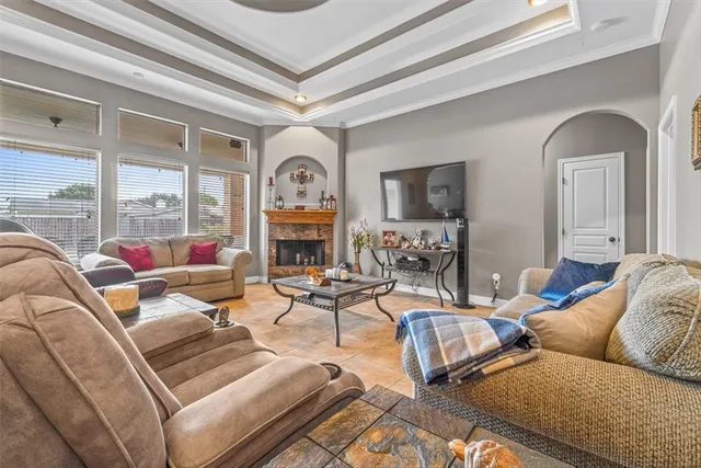 a living room with fireplace furniture and a large window