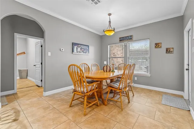 a view of a dining room with furniture and a chandelier