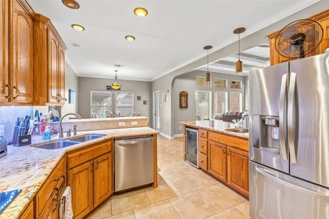 a large kitchen with stainless steel appliances granite countertop a sink and cabinets