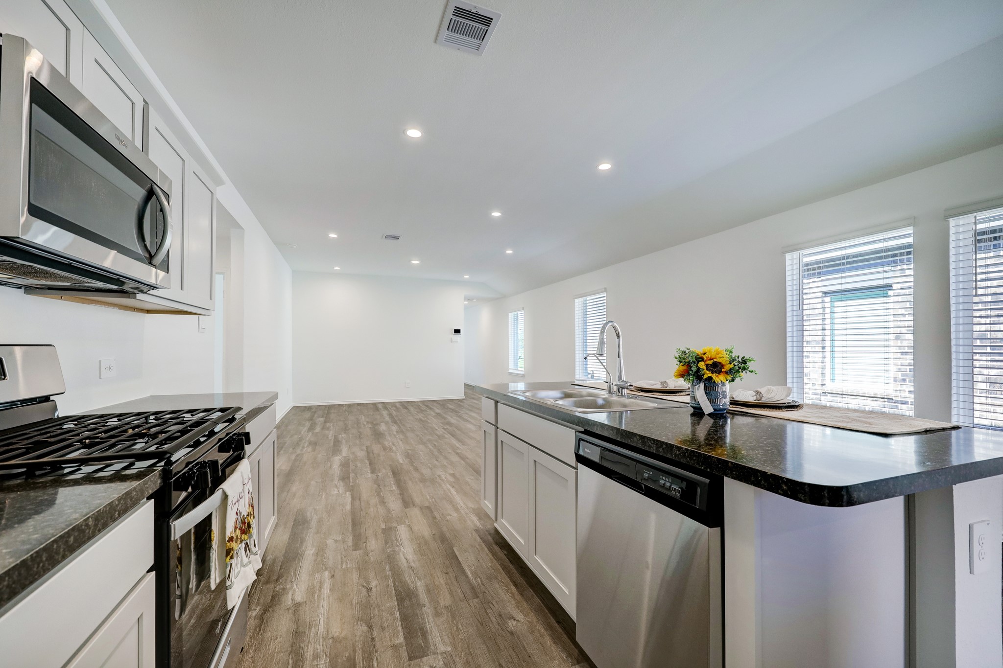 5314 Castlebury Meadows Dr Spring Spring, TX 77373 - Photo 10 of 19 Open-concept kitchen featuring granite countertops, stainless steel appliances, and an oversized island ideal for meal prep and casual seating.
