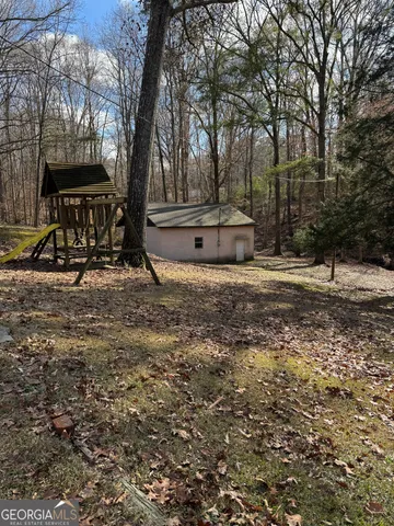 a view of outdoor space with deck and trees