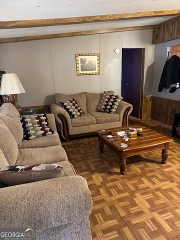 a living room with a couch and a walk in closet