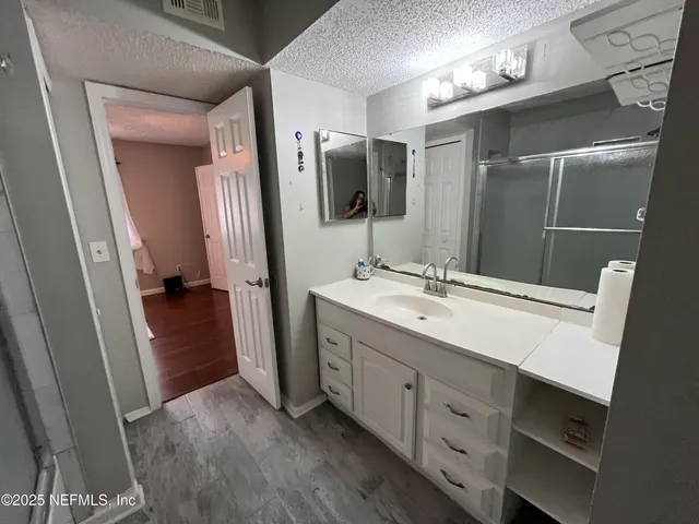a bathroom with a double vanity sink and mirror