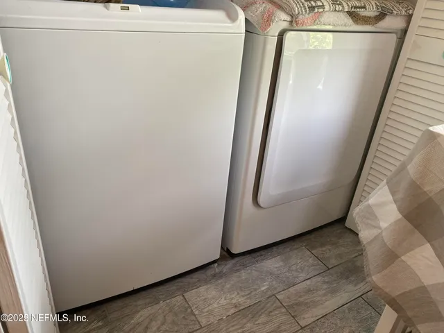 a view of a storage and utility room with a washer dryer