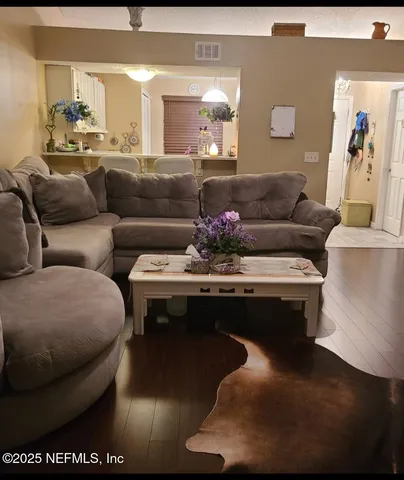 a living room with a couch and a potted plant