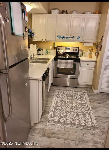 a view of a patio with table and chairs potted plants with palm trees