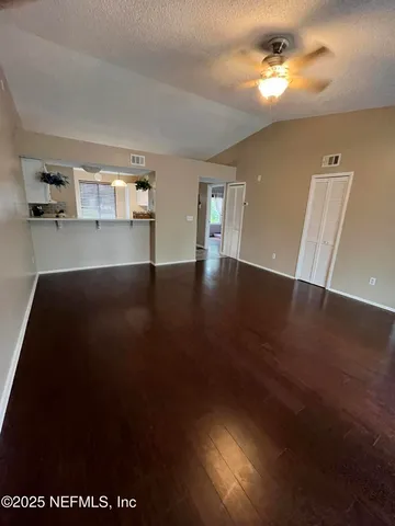 a view of a livingroom with wooden floor