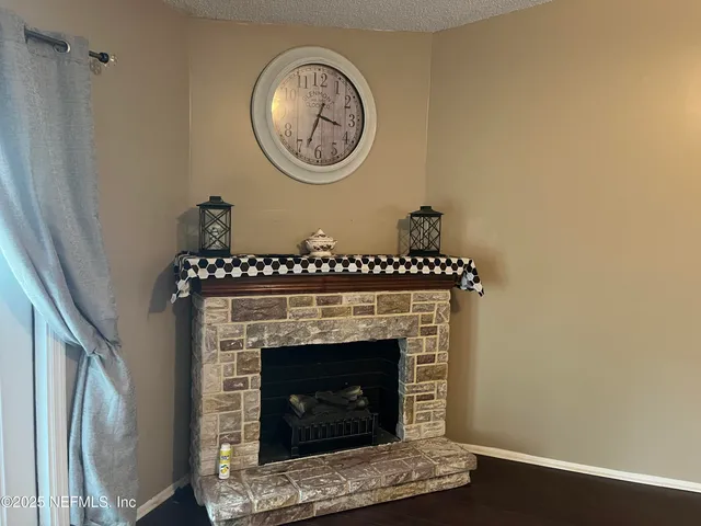 a living room with a fireplace and a wooden floor