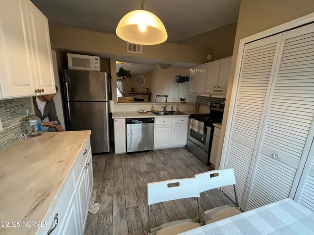 a kitchen with refrigerator and cabinets