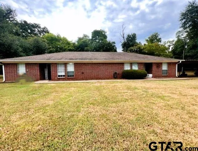 a house with trees in the background