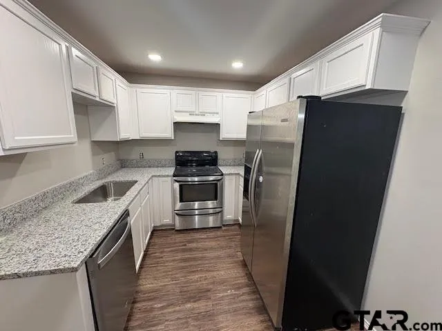 wooden floor in an empty room with a mirror