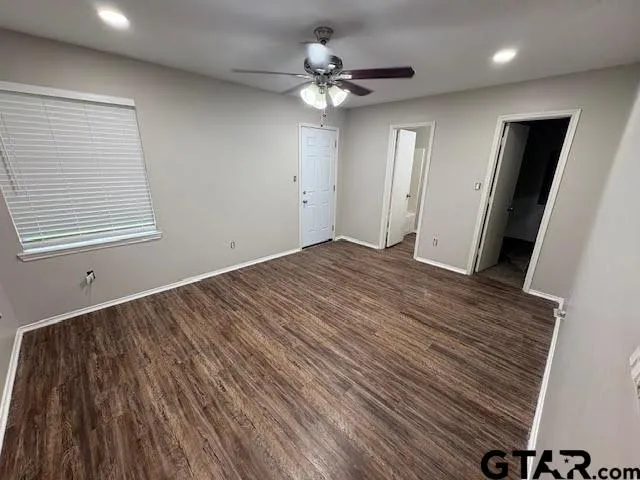 an empty room with chandelier fan