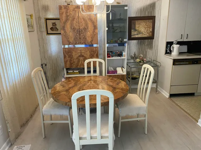 a view of a dining room with furniture and a chandelier