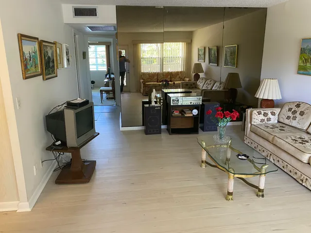 a living room with furniture gym equipment and a floor to ceiling window