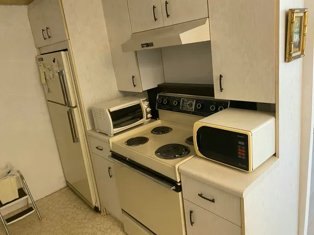 a kitchen with a stove and a refrigerator