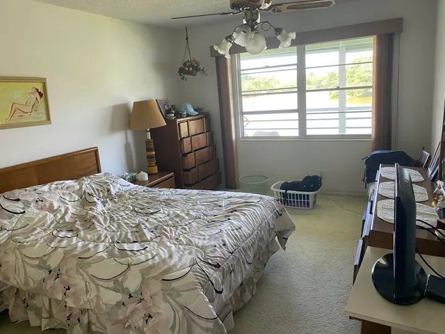 a bedroom with bed and window