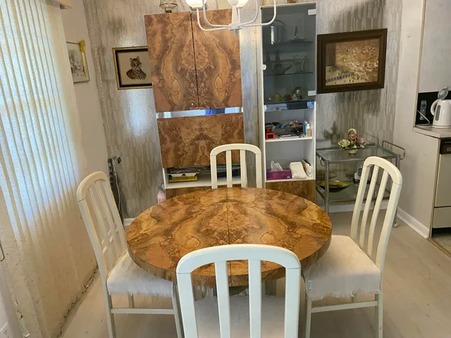 a view of a dining room with furniture and a mirror