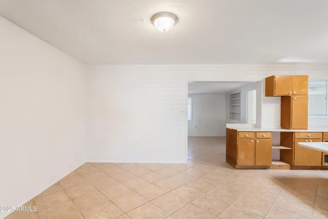 an empty room with a painting on the wall