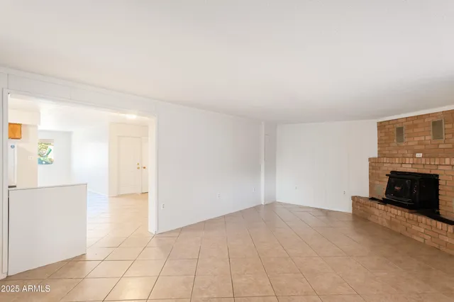 a view of a livingroom with an empty space and a fireplace