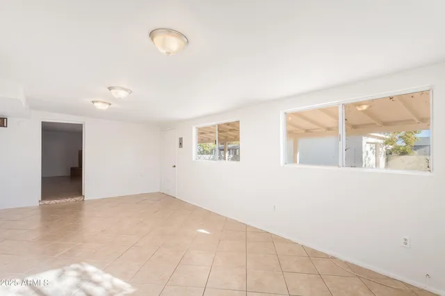 an empty room with windows and entrance