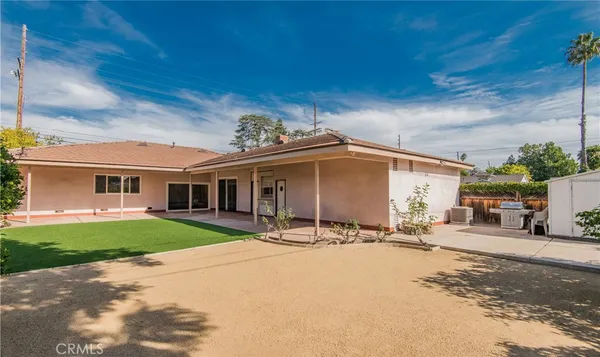 a table and chairs under an umbrella