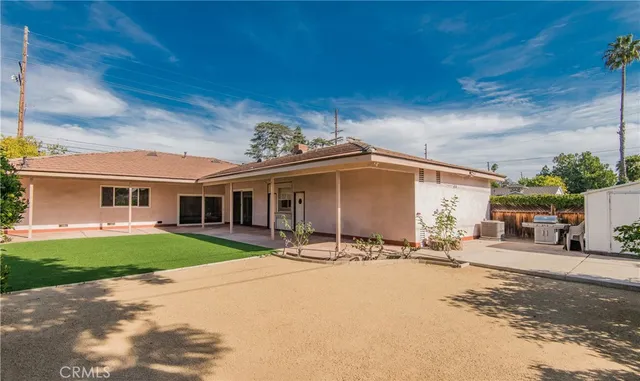a table and chairs under an umbrella