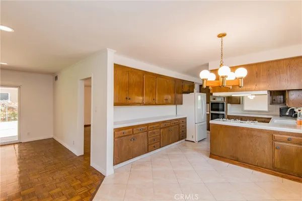 a kitchen with stainless steel appliances granite countertop a sink and a refrigerator