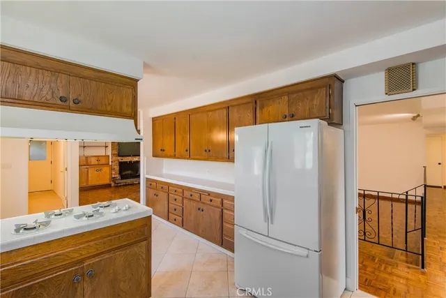 a kitchen with stainless steel appliances a refrigerator and a stove top oven