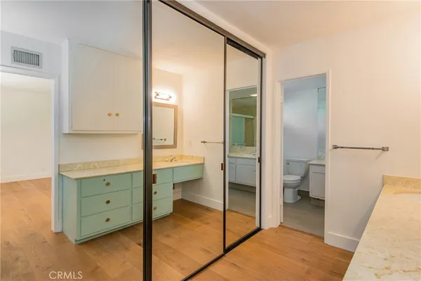 a bathroom with a double vanity sink toilet and tub