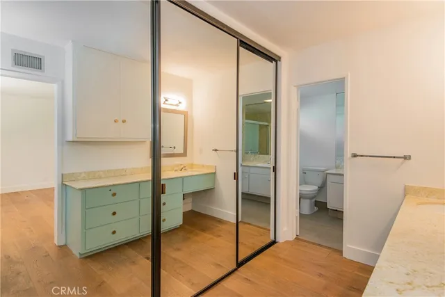 a bathroom with a double vanity sink toilet and tub