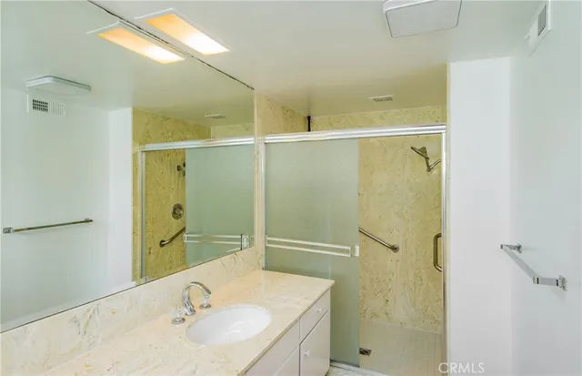 a bathroom with a sink and shower