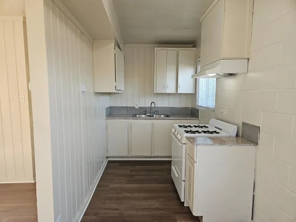 a kitchen with a stove sink and a refrigerator
