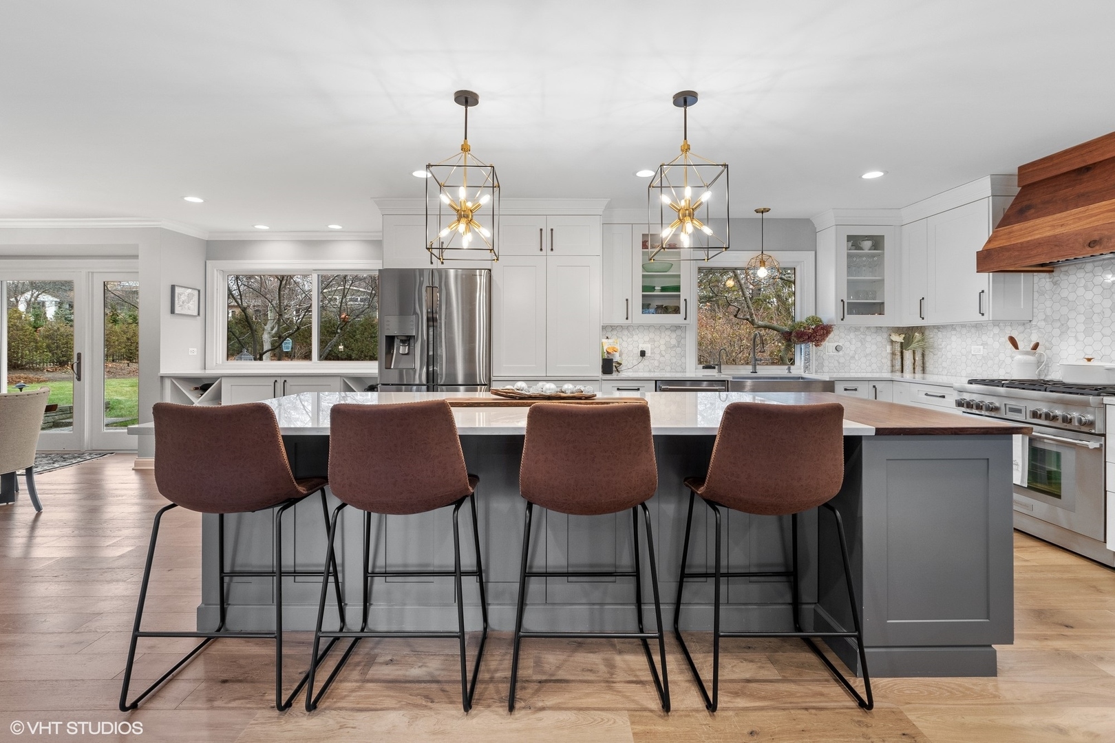 106 Park Lane Lake Bluff, IL 60044 - Photo 10 of 36 a kitchen with a dining table chairs sink and granite counter top