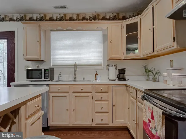 a kitchen with stainless steel appliances granite countertop a sink and a stove