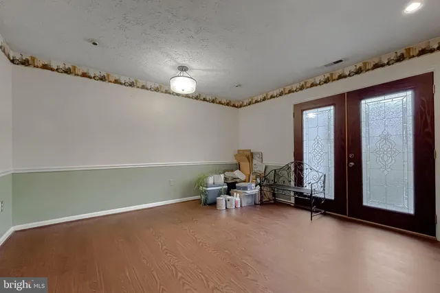a view of a room with furniture and a window