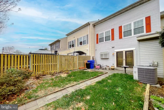 a view of a house with a yard and fence