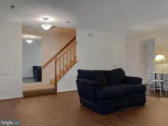 a living room with furniture and stairs