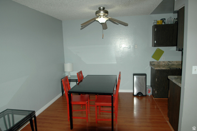 46 Lester Avenue, Unit G 24 Murray, UT 84107 - Photo 8 of 16 Dining and kitchen area featuring wood-finish flooring, a ceiling fan fixture.