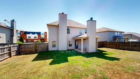 an aerial view of a residential apartment building with a yard