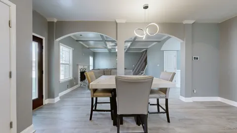 a view of a dining room with furniture and a chandelier